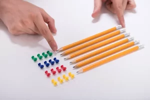 OCD Depositphotos 202809942 Stock Photo Person Hand Arranging Pencils Multi 1 300x200