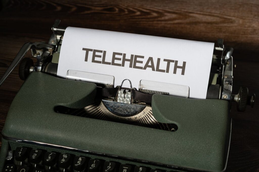 A vintage typewriter showcasing the word 'Telehealth' on paper, symbolizing modern healthcare.